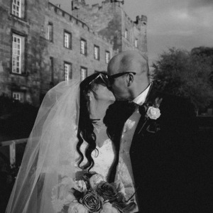 A timeless kiss beneath the stone arches — love, legacy, and a moment that will never fade.
